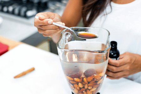 Can homemade almon milk be frozen? A woman making homemade almond milk